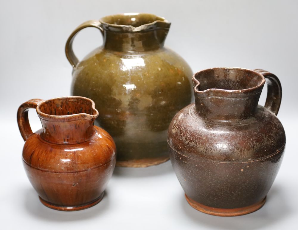 Three various 19th century Sussex terracotta jugs, largest 28cm